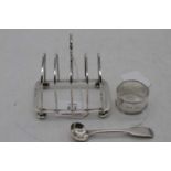 A George V silver toast rack having four arched divisions with a with loop handle on squat feet,