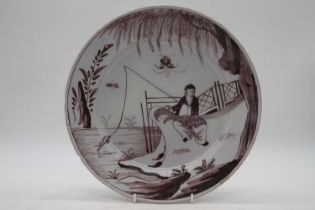 An 18th century Delft charger, manganese decorated with a fisherman, dia. 30cmProfessionally