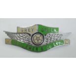 A Grey-Green Geo. Ewer & Co Ltd. chromed metal and enamelled coach drivers cap badge, with winged