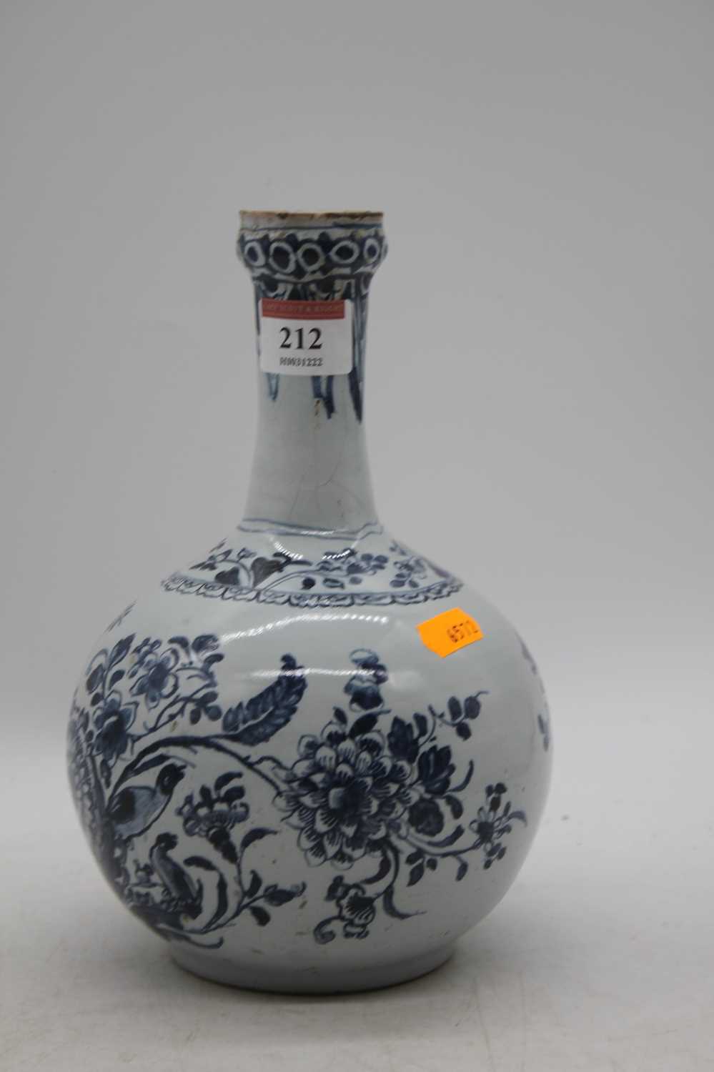 An 18th century Delft bottle vase, decorated with flowers, h.22cm Has been restored.