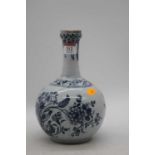 An 18th century Delft bottle vase, decorated with flowers, h.22cm Has been restored.