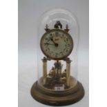 A Schatz brass anniversary clock, housed under a glass dome, height 29cm