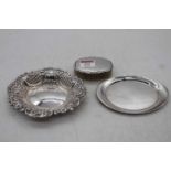 A Victorian style silver bonbon dish of shaped oval form having repoussee floral and C-scrolling