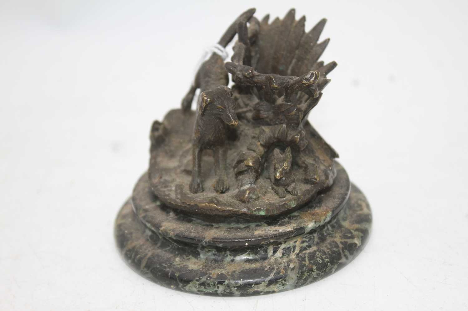 A bronze model of a dog and a hare, mounted upon a polished hardstone plinth, h.6.5cm