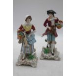 A pair of Sitzendorf porcelain figures, each shown in 18th century dress, h.19cm