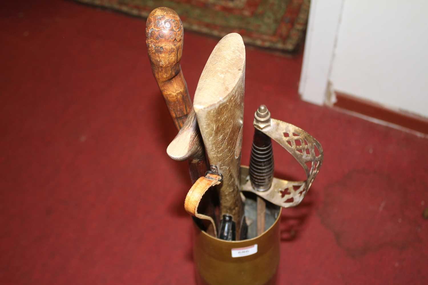 A brass artillery shell case, containing a knife-sharpener, air rifle model, and two walking sticks - Image 2 of 2