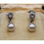 A pair of Ciro white metal, cultured pearl and paste set ear clips, with screw backs and in fitted