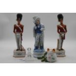 A pair of porcelain figures of soldiers, height 31cm, together with another porcelain figure, a