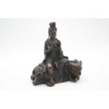A reproduction bronzed figure of a deity, in seated pose upon an elephant, h.23cm