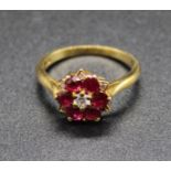 An 18ct gold, ruby and diamond cluster ring (rubies possibly heat-treated), setting dia.10mm, 2.