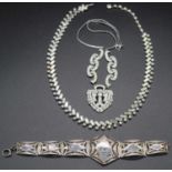 A white metal filigree and niello sectional bracelet; together with two paste set necklaces (3)