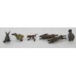 A small collection of cold painted figures to include a pair of leaping hares, length 5.5cm, three