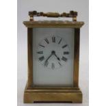 A large early 20th century lacquered brass cased carriage clock having an enamelled dial with