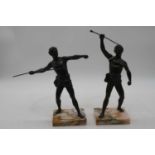 A pair of bronzed figures of athletes, each shown rasing a spear, mounted upon a polished