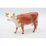 A Beswick model of a Hereford cow, No.948, h.13cmOne horn has been re-attached.Lightly crazed