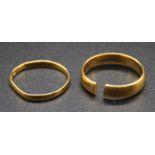 A 22ct gold wedding band (cut); and one other narrow lightweight 22ct gold band ring, gross weight
