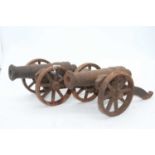 A pair of miniature cast iron models of cannons, h.14cm