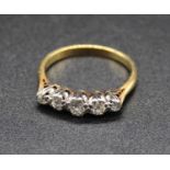 An 18ct gold diamond five stone ring, arranged as five graduated old round cuts, the centre stone