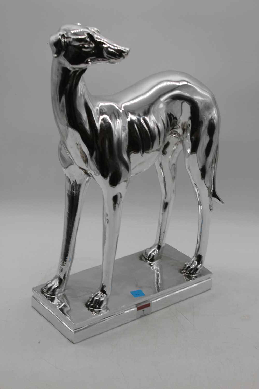 A silver resin model of a greyhound, in standing pose, height 46cm