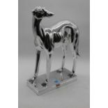 A silver resin model of a greyhound, in standing pose, height 46cm
