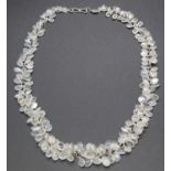 A contemporary silver and multi-moonstone set necklace, the moonstone cabochons being graduated