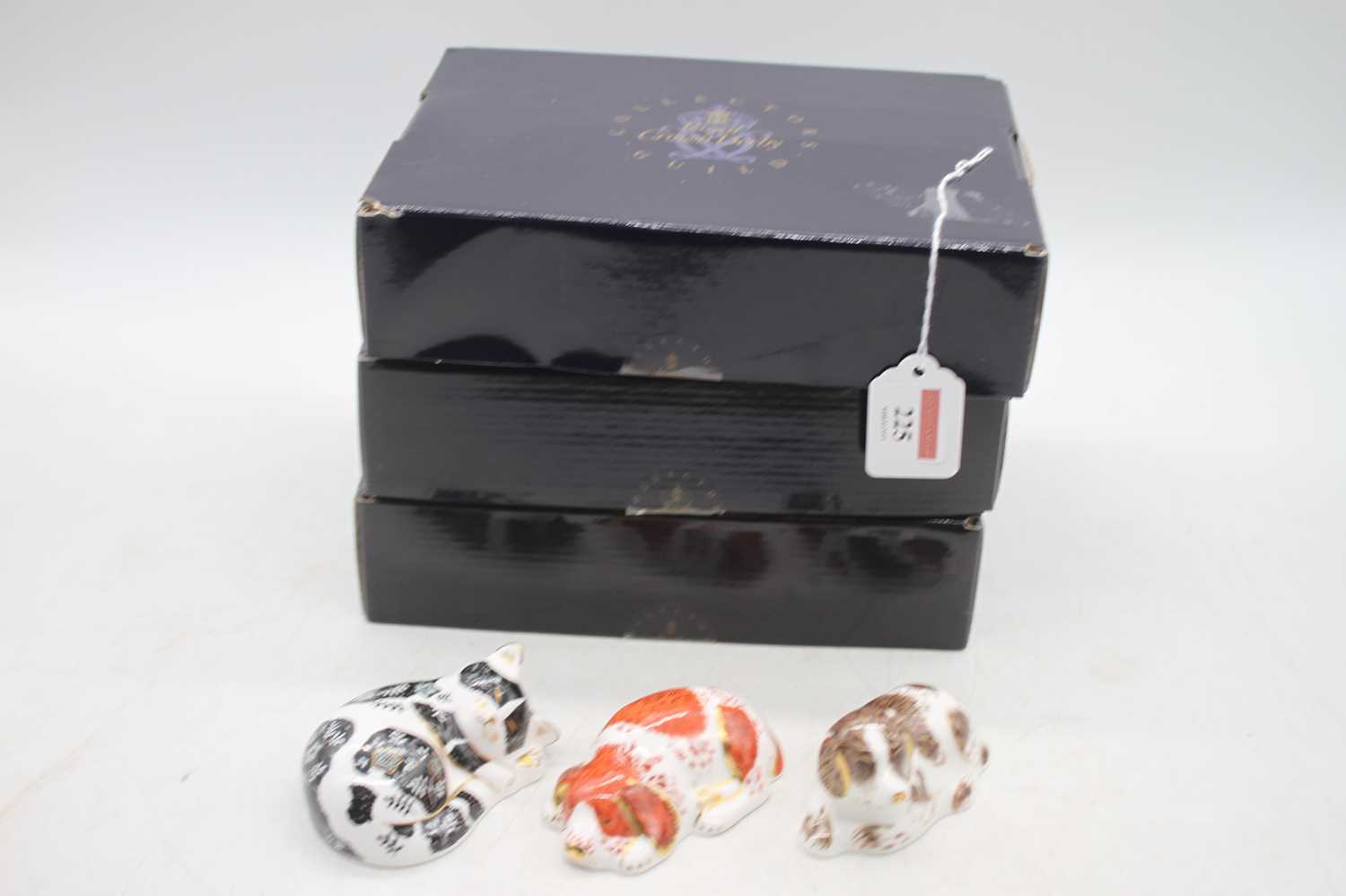 A Royal Crown Derby model of a dog 'Scruff'; together with another of a puppy; and a cat 'Misty',