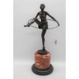 An Art Deco style bronze figure of a dancer, mounted upon a rouge marble plinth, height