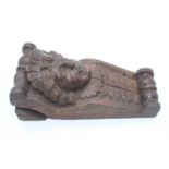 A 19th century carved oak bracket decorated with a female mask, height 29cm