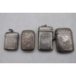 An Edwardian silver vesta of hinged rectangular form having foliate engraved decoration and