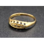 A yellow metal diamond ring, set with five small rough cuts in a graduated lozenge setting, with