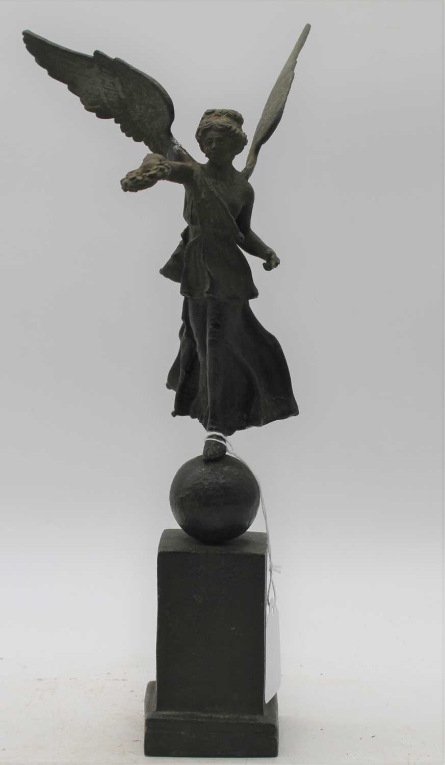 A 19th century bronze figure of Nike, showing standing upon a ball and square plinth, height 34cm