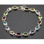 A modern silver semi-precious set bracelet, to include peridot, garnet, amethyst and blue topaz