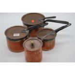 A graduated set of three Victorian copper pans, together with another similar, largest dia. 15cm