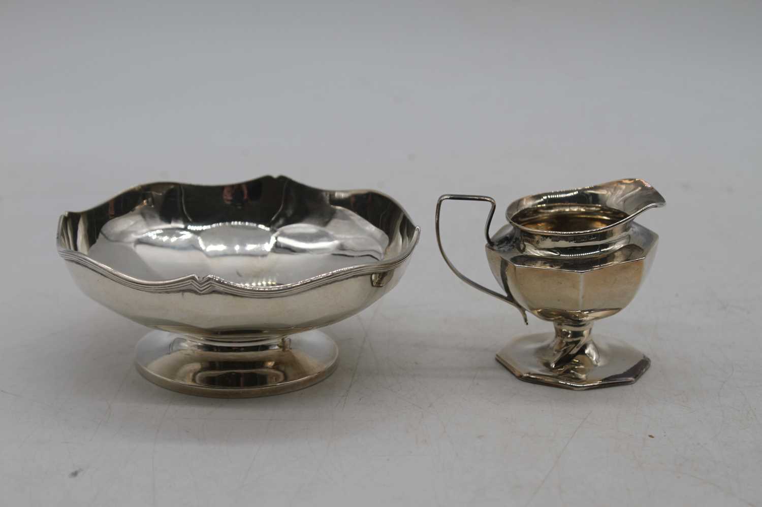 A George V silver bonbon dish of shaped circular form on domed foot, together with an Edwardian