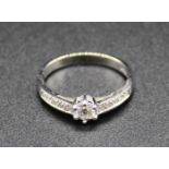 A modern 18ct white gold diamond dress ring, the claw set round brilliant weighing approx 0.2