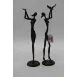 A near pair of bronze female figures, largest height 33cmBroken bird missing from hands.