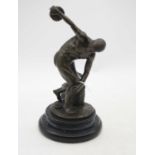 A bronzed figure of a discus-thrower, signed Mirdn, mounted upon a polished hardstone plinth, h.25.