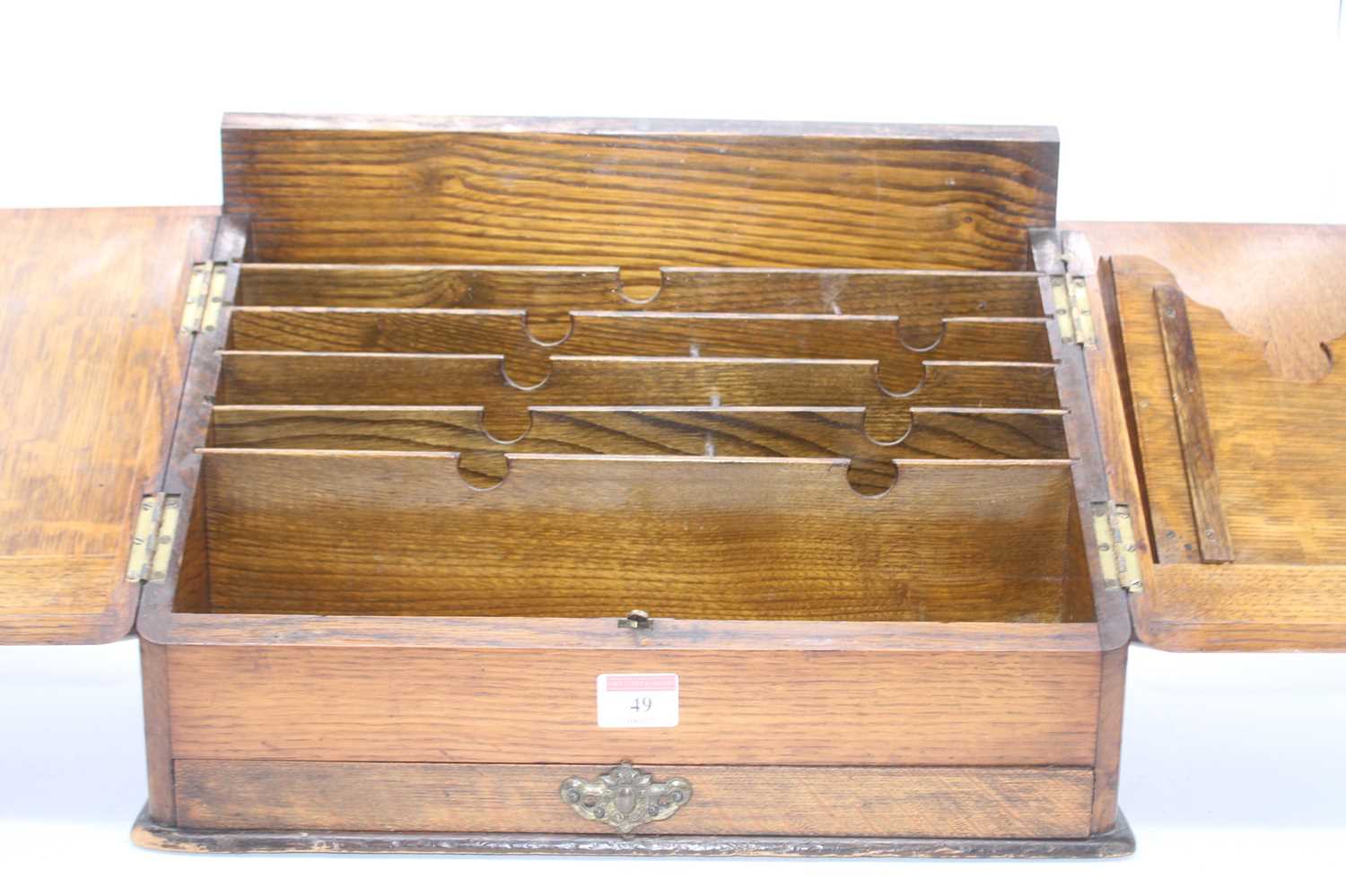 A 19th century oak stationery cabinet, the doors opening to reveal an arrangement of pigeon holes,