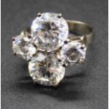 A white metal and cz set dress ring, arranged as two pairs of round brilliant cubic zirconia to a