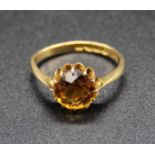 An 18ct gold and citrine solitaire ring, the claw set round cut citrine weighing approx 1.5
