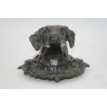 A bronzed inkwell, in the form of a dog's head, h.10cm
