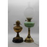 A Victorian brass oil lamp, height 61cm together with another, and spares