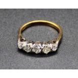 An 18ct gold diamond five stone ring, the five graduated and claw set old cuts in a line setting,
