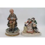 A continental porcelain figure group, the figures shown in 18th century dress, height 22cm, together
