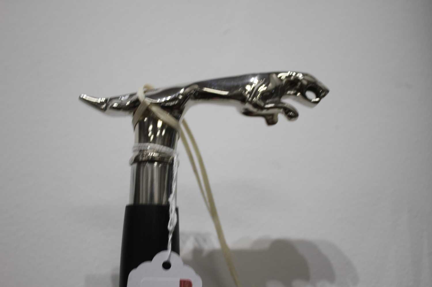 A reproduction walking stick, the handle in the form of a Jaguar car mascot, 19cm