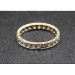 A white metal and white sapphire set eternity ring, having engraved shank stamped 9ct and tests as