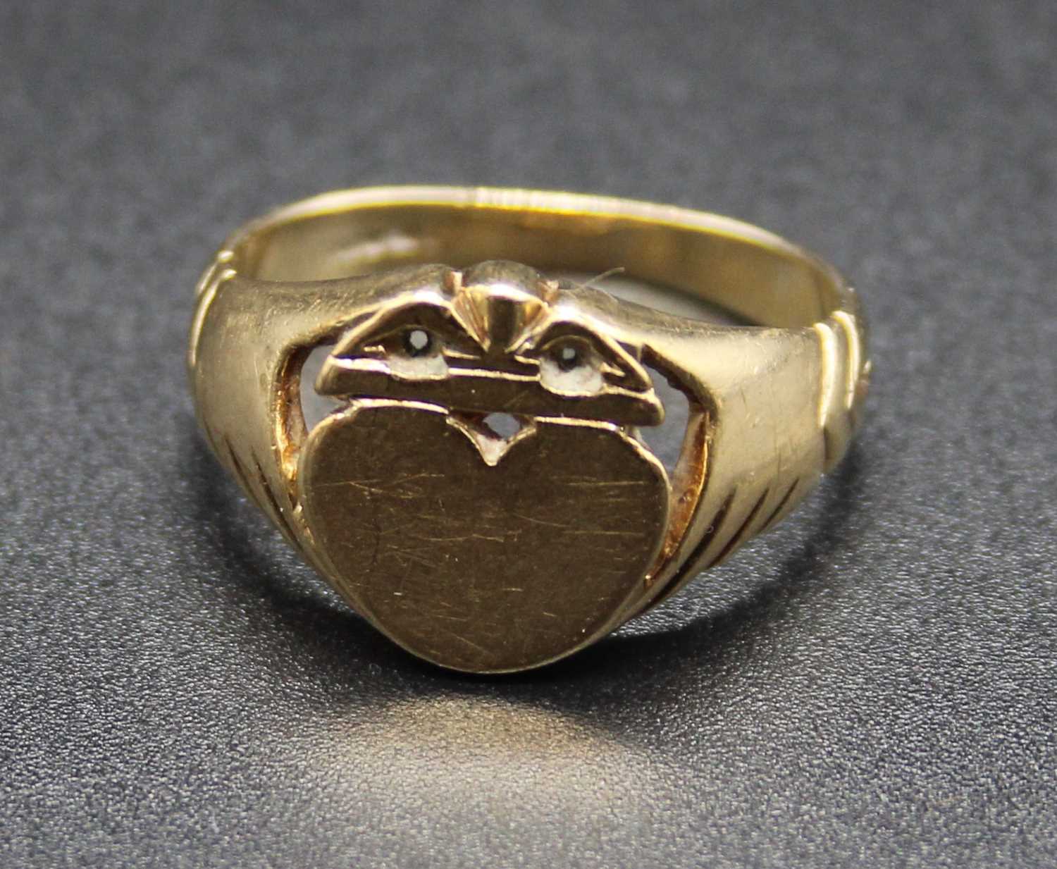 A 9ct gold signet ring, the tablet being heart shaped and surmounted with a crown, sponsor TAD, 4.