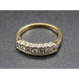 A 9ct gold diamond half hoop ring, arranged as seven illusion set round brilliants, total diamond