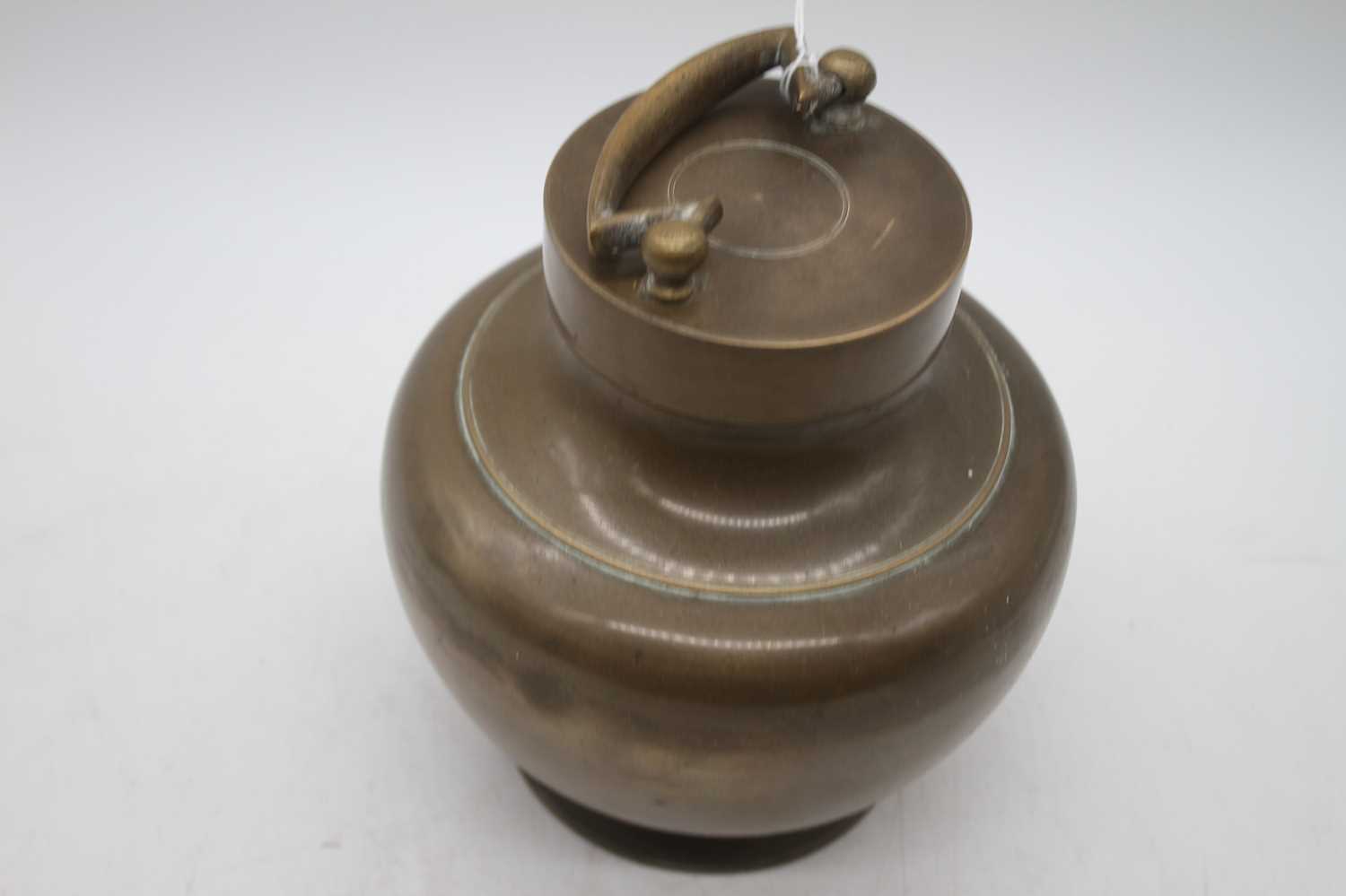An Indian brass holy water vessel, of baluster form, height 21cm including handle - Image 3 of 3