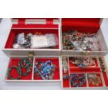 A jewellery box containing various costume jewellery, faux amethyst bracelet, paste set brooches,